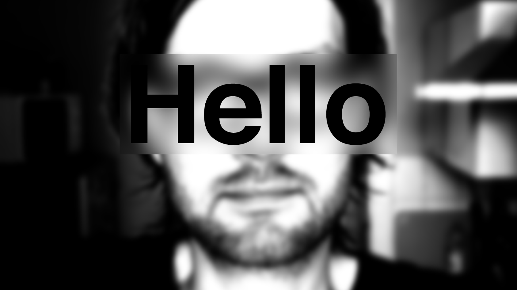 A blured black and white portrait image with the word hello world on top